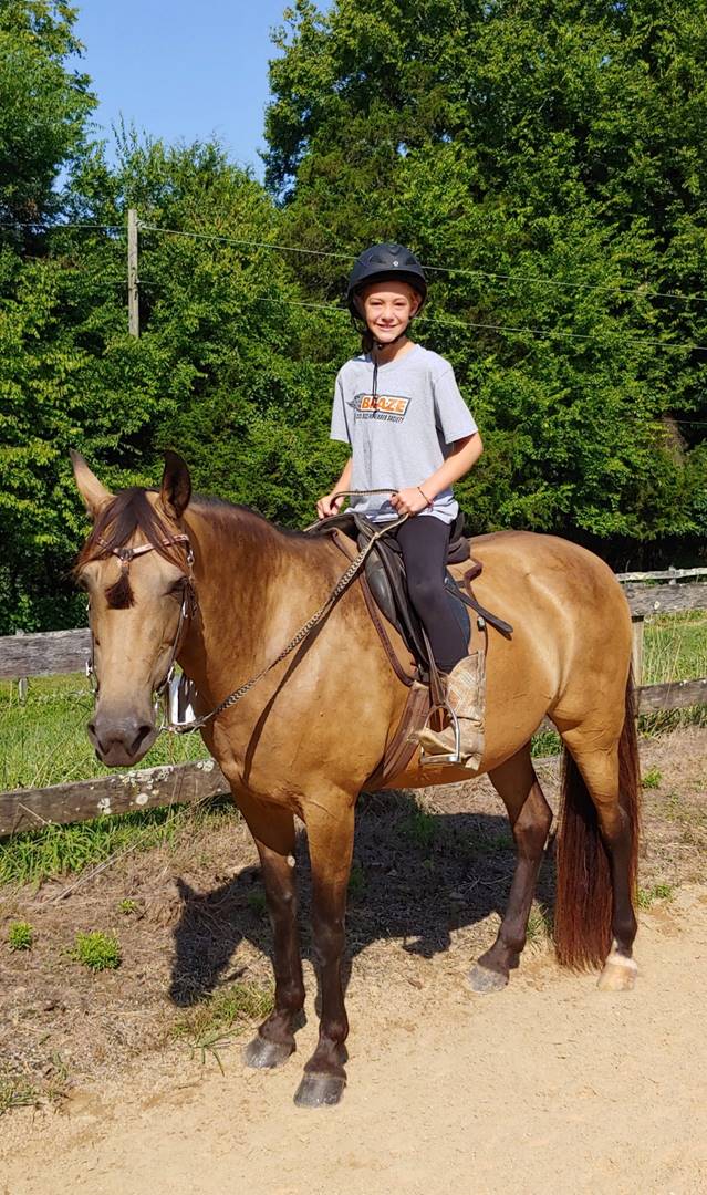 A child riding a horse

Description automatically generated with medium confidence